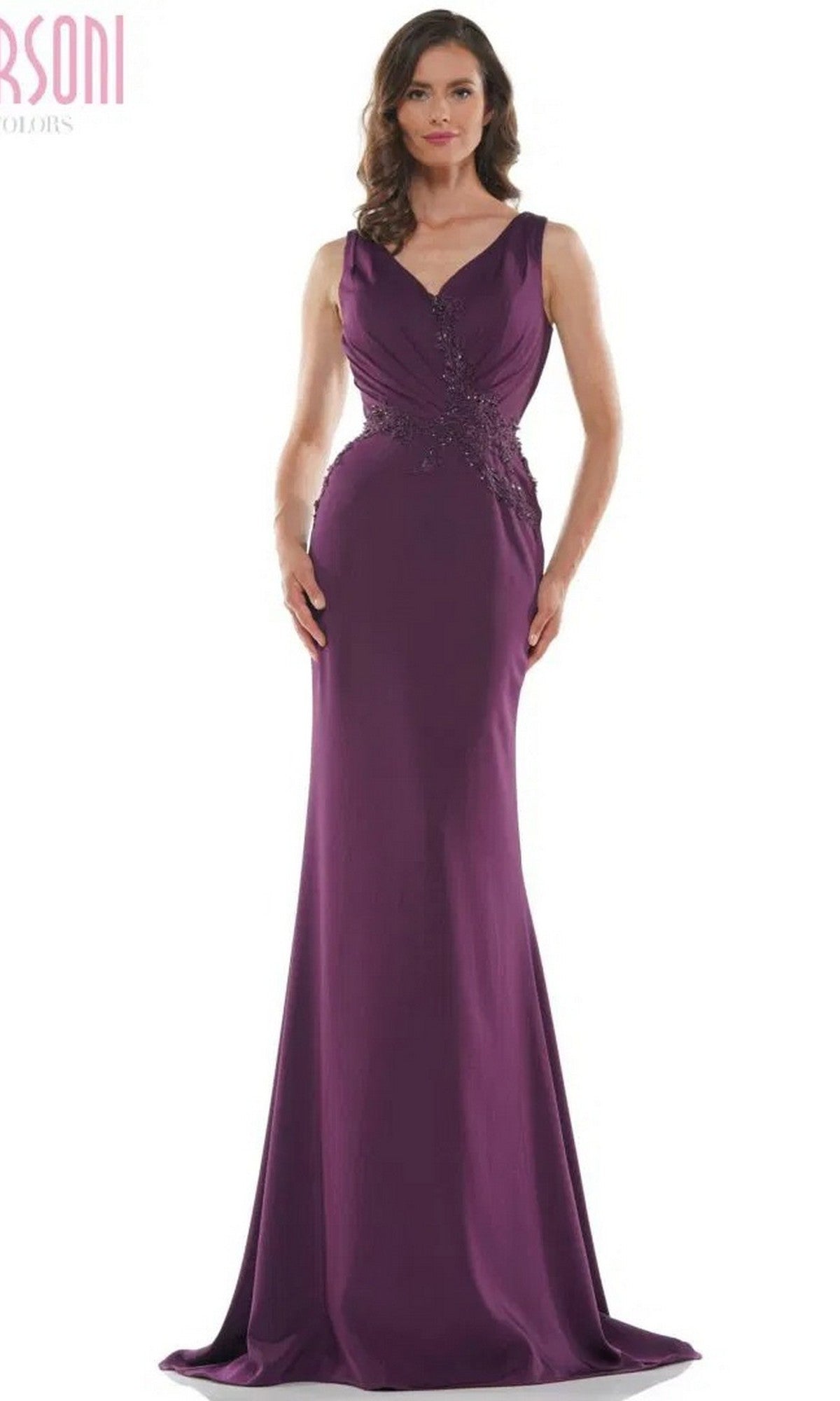 A woman wearing the Marsoni MV1054 long formal dress in eggplant, a sleeveless floor-length trumpet silhouette with a fitted embroidered bodice and subtle waist embellishments.